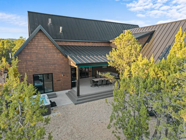 Modern architectural design featuring a shingle-sided exterior and a standing seam metal roof