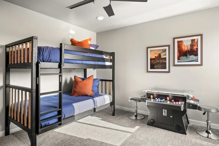 Bunkroom featuring a dark wood-finish bunk bed, recessed lighting, and a ceiling fan