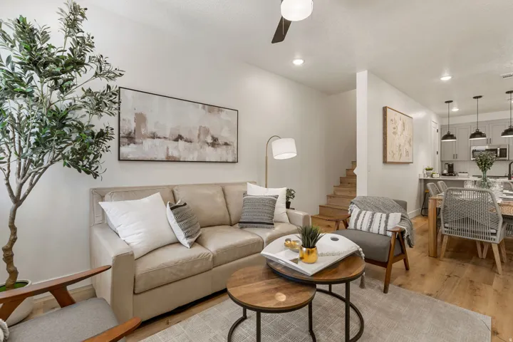 Open-concept living area featuring wood-finish flooring, recessed lighting, and a ceiling fan