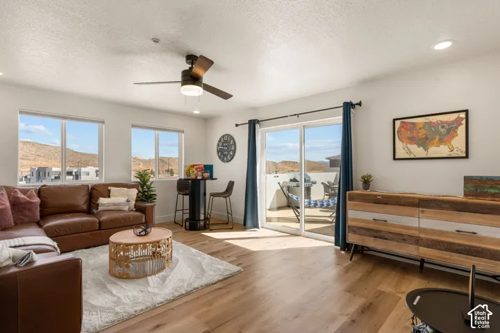 Open living area featuring wood-finish flooring, recessed lighting, and a ceiling fan