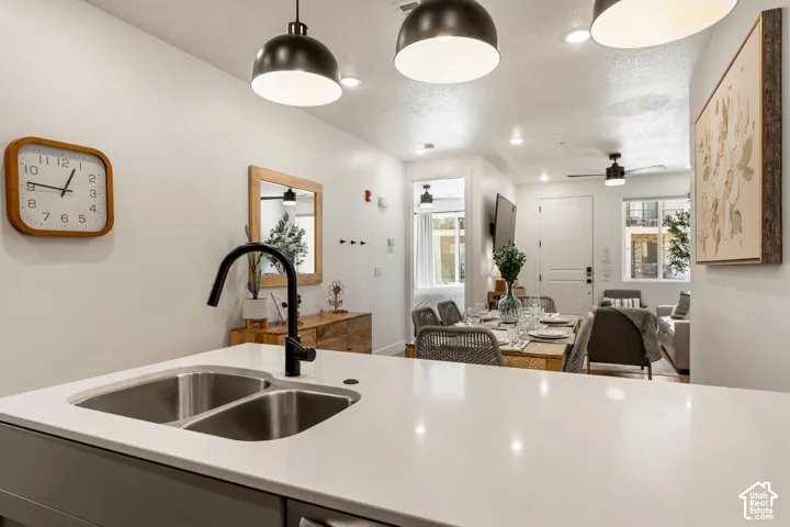 Kitchen island featuring a dual stainless steel sink and a matte black gooseneck faucet