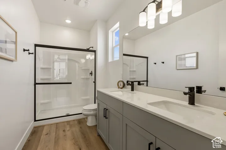 Contemporary bathroom featuring a double vanity with light gray cabinetry and white countertops