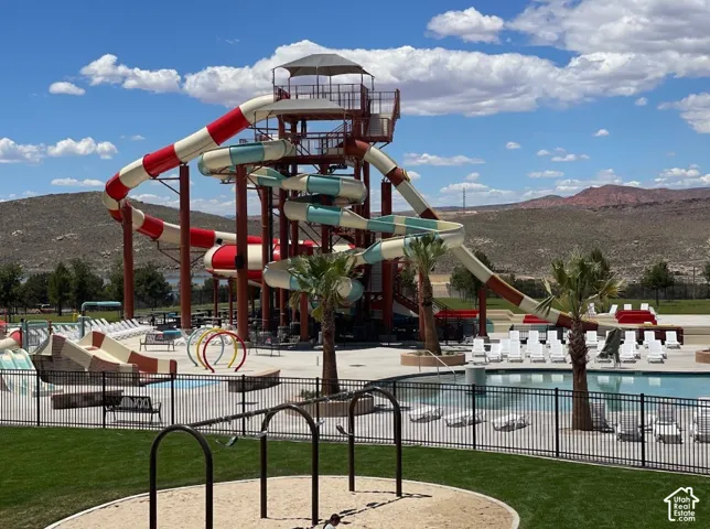 Expansive water park area featuring a multi-story waterslide complex, a large swimming pool, and dedicated splash pads