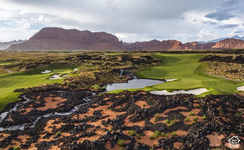 Expansive golf course setting featuring manicured greens, sand bunkers, and a water hazard