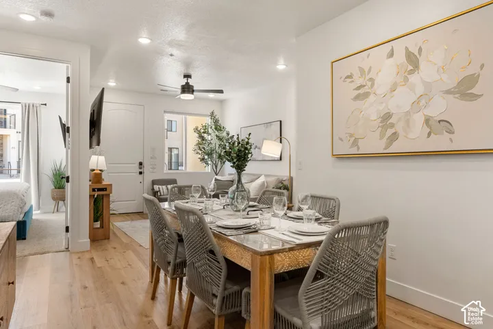 Open-concept living space featuring wood-finish flooring, recessed lighting, and a white interior door