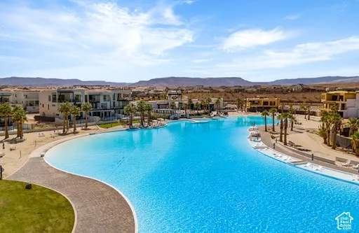 Expansive blue lagoon with surrounding sandy beaches and modern residences