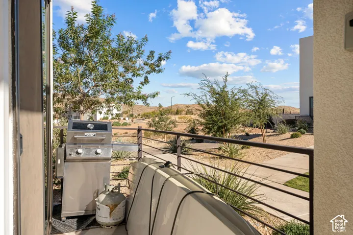 Outdoor balcony featuring a metal railing and a stucco exterior wall