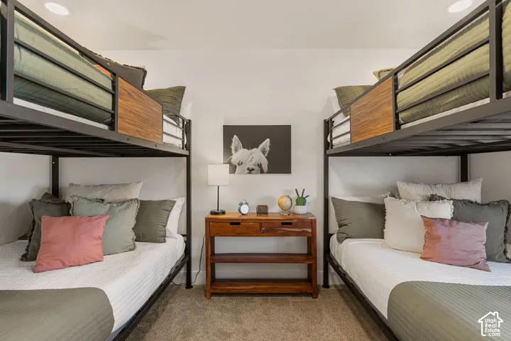 Bedroom featuring two metal-frame bunk beds with wood-finish paneling