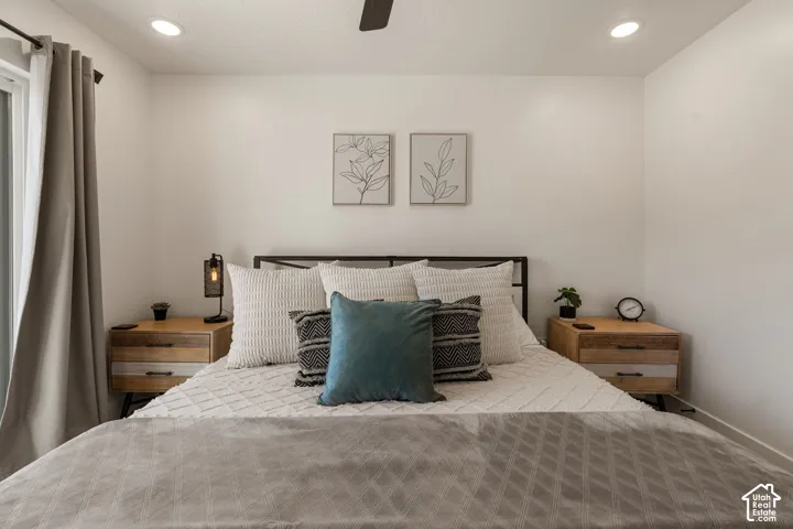 Bright bedroom featuring recessed lighting, a ceiling fan, and a sliding glass door