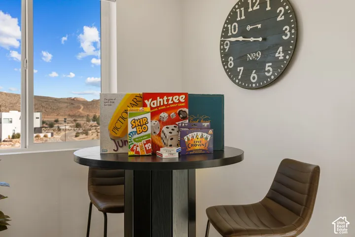 Window with desert landscape, light neutral walls, and a round wall clock