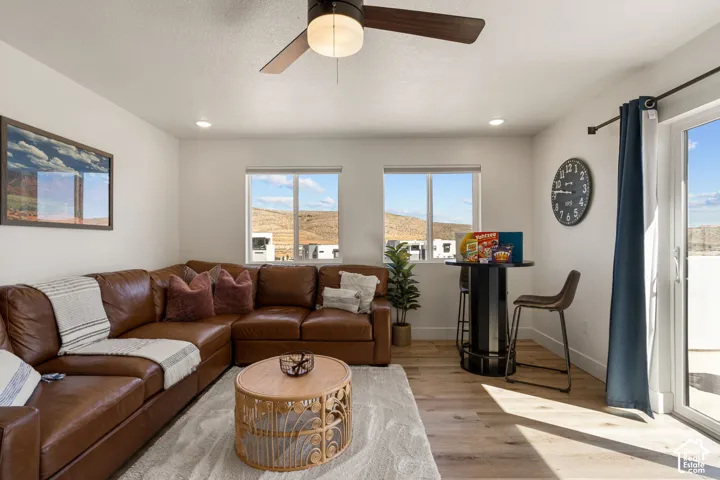 Spacious living area featuring wood-finish flooring, recessed lighting, and a ceiling fan