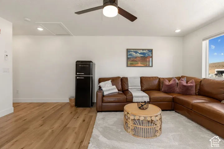 Living space featuring wood-finish flooring, recessed lighting, and a ceiling fan