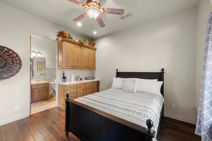 Wood-finish flooring throughout, with a ceiling fan featuring integrated lighting