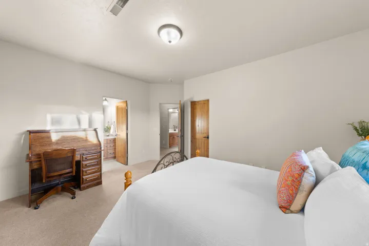 Carpeted room with light-colored walls and a semi-flush mount ceiling light
