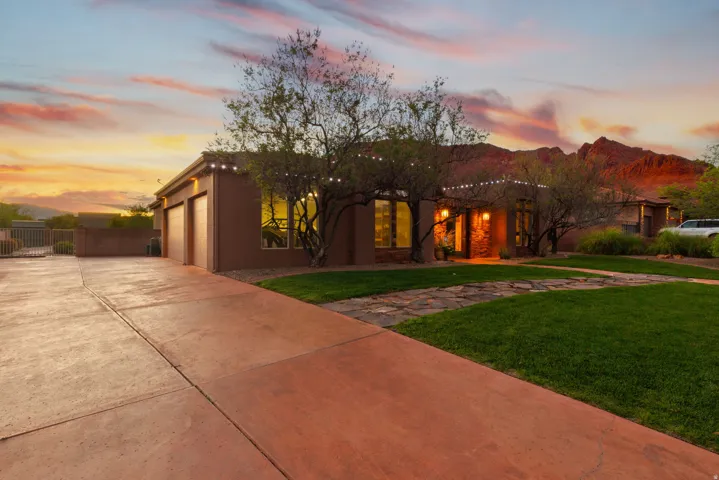 Southwestern-style residence featuring a prominent two-car garage