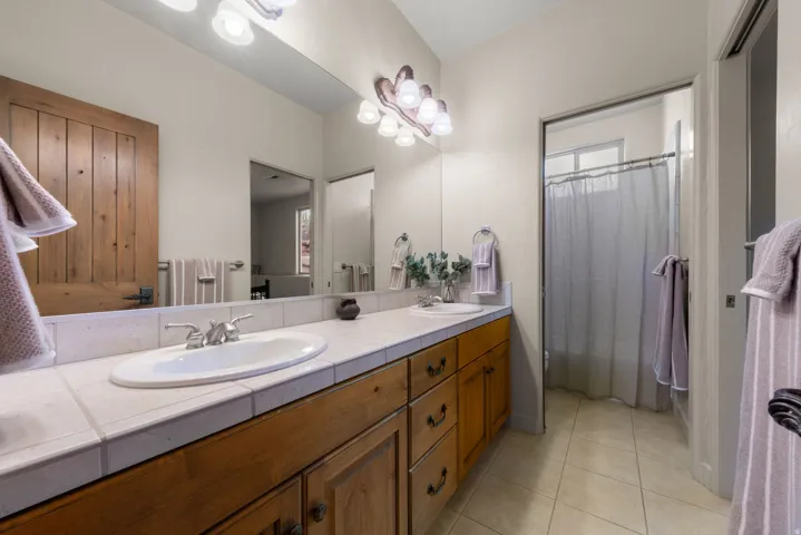 Double vanity with a tile countertop and integrated sinks