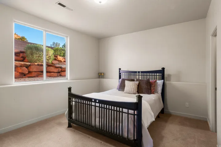 Spacious room featuring neutral carpeting and light-toned walls