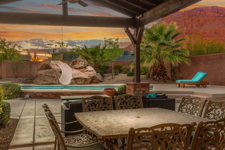 Covered patio featuring a ceiling fan, providing a comfortable outdoor living area