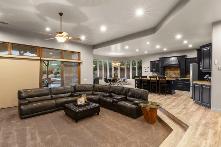 Open-concept living area featuring recessed lighting, a ceiling fan, and carpeted flooring