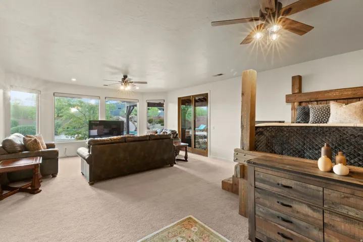 Spacious interior featuring neutral carpeting, recessed lighting, and multiple windows