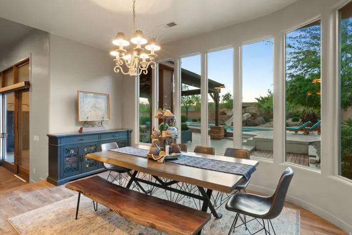 Dining space with wood-finish flooring and a decorative chandelier