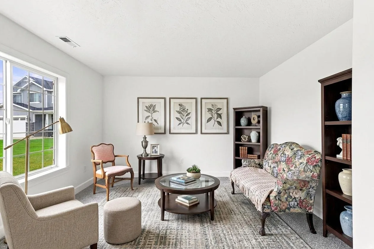 Bright living space featuring white walls and a large window overlooking a landscaped exterior. AI generated photo