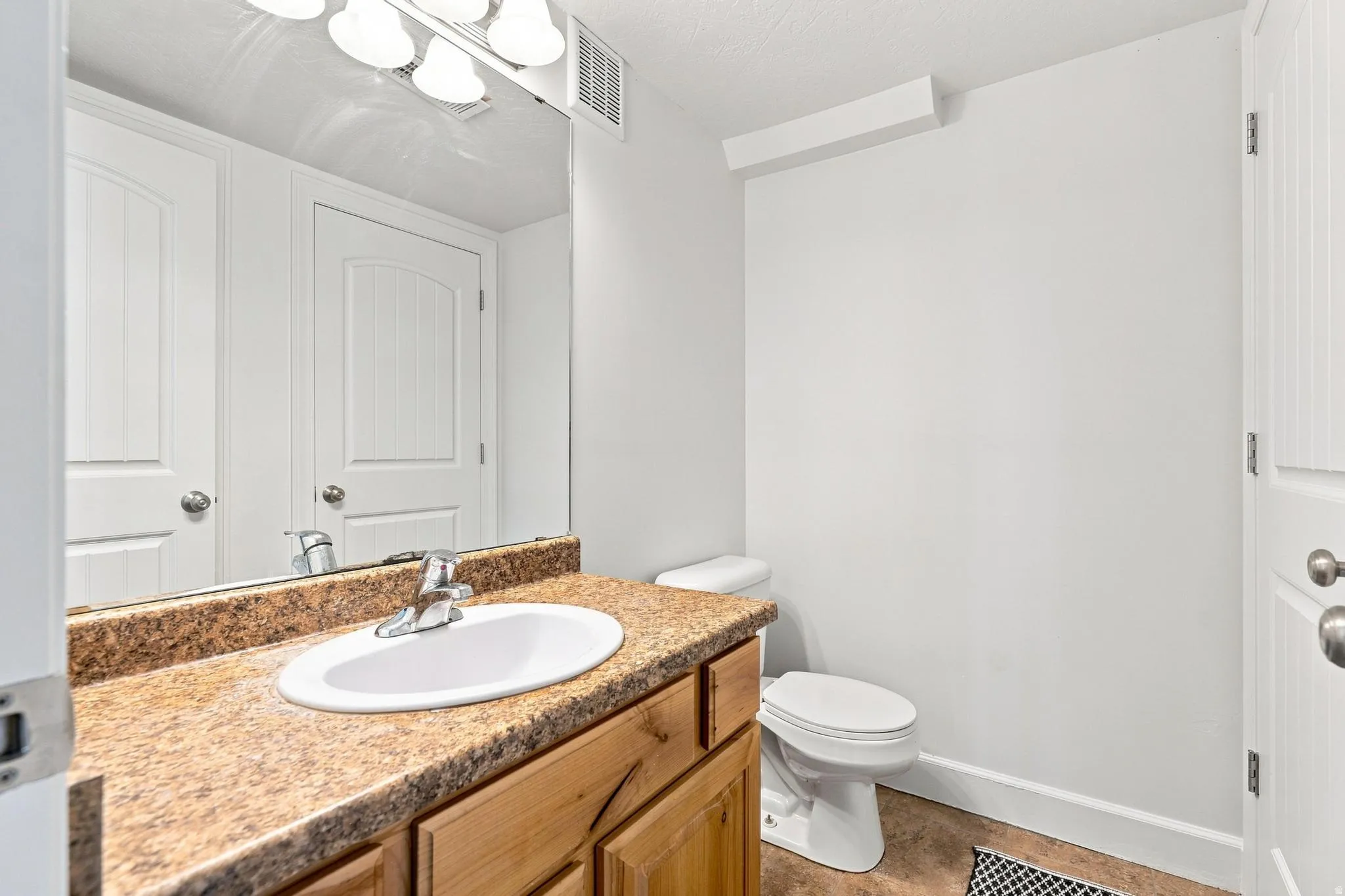 Bathroom vanity with a composite countertop and integrated sink