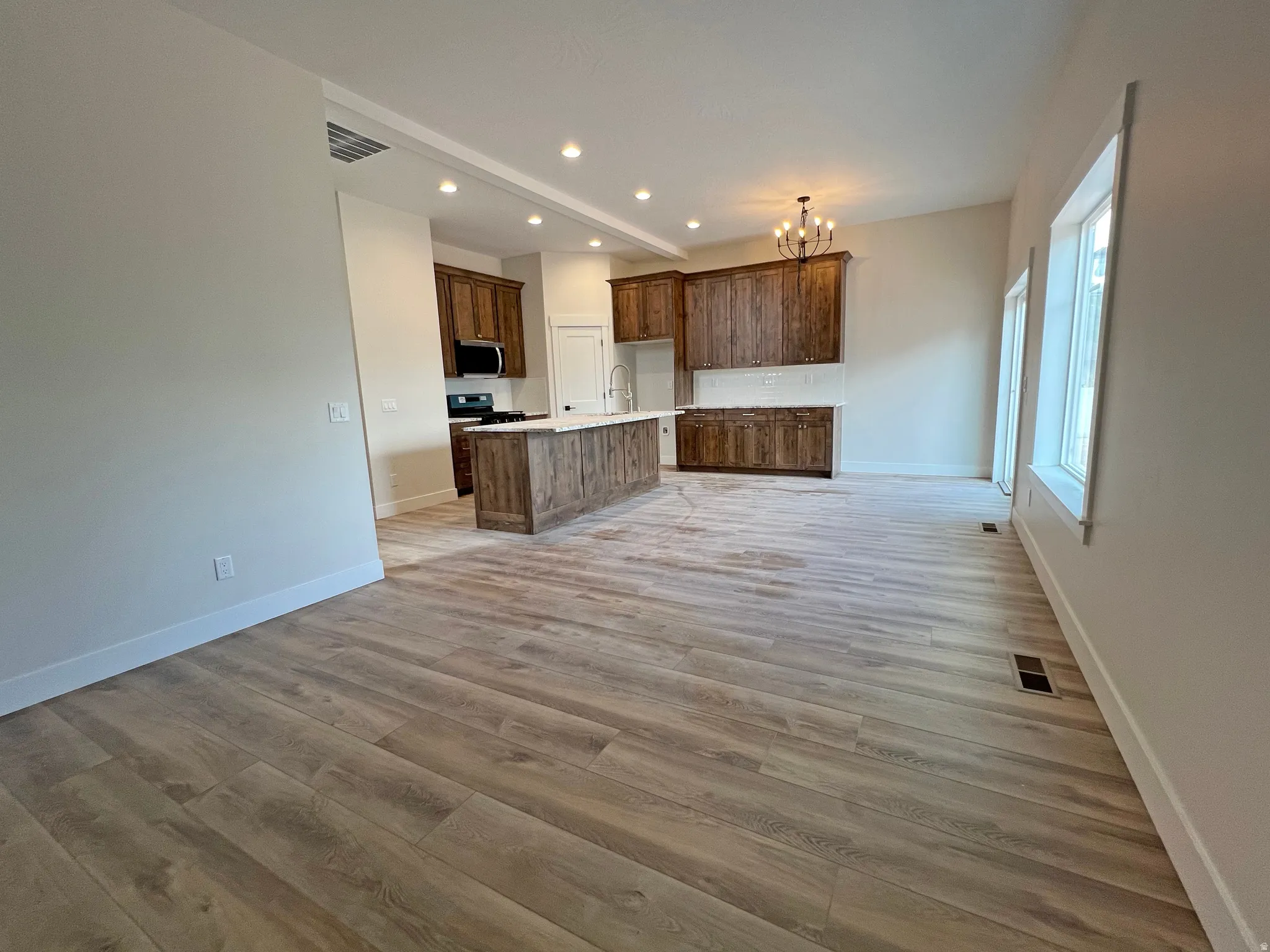 Open-concept living area featuring wood-finish flooring