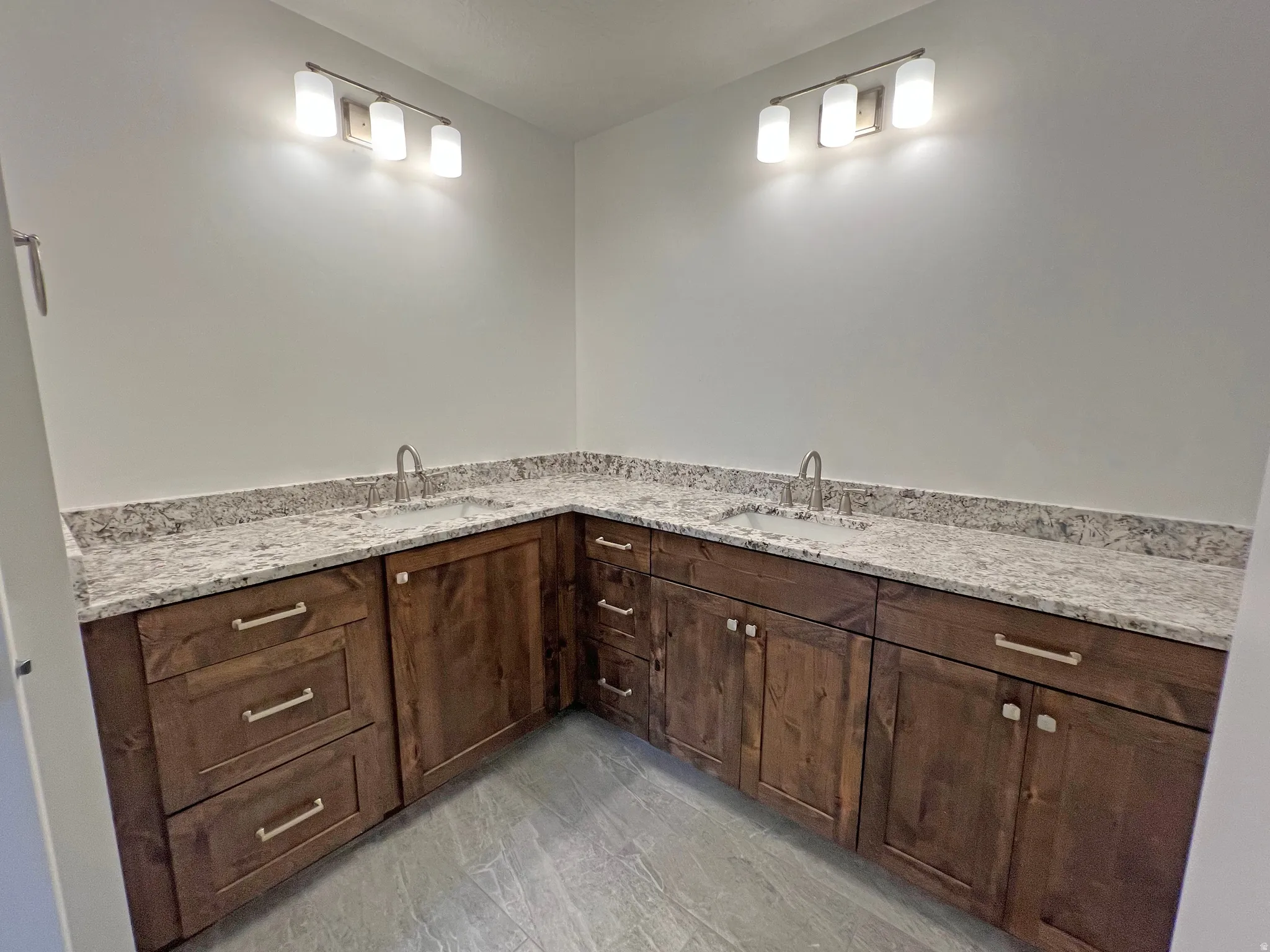 Dual vanity with stone countertops and undermount sinks