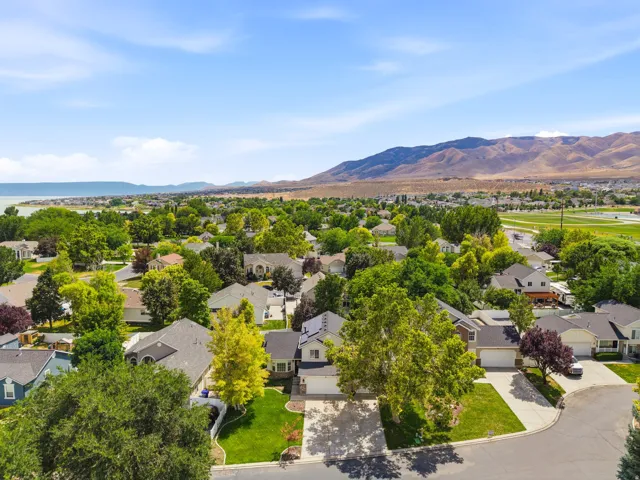 Aerial perspective showcasing a residential neighborhood with a mountain backdrop