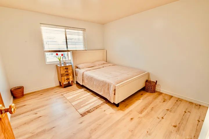 Bright room featuring light wood-finish flooring and neutral wall tones