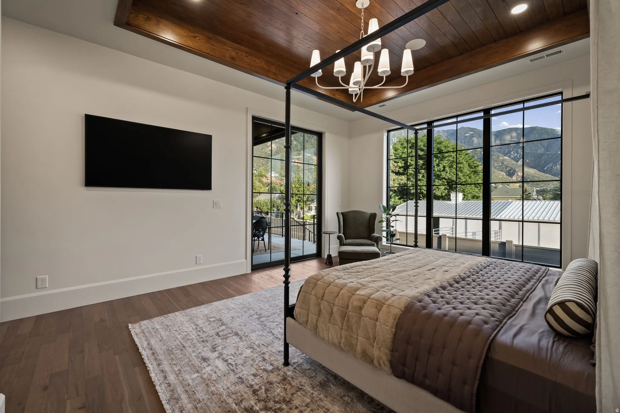 Room featuring wood-finish flooring, a wood-paneled ceiling with exposed beams, recessed lighting, and a white chandelier