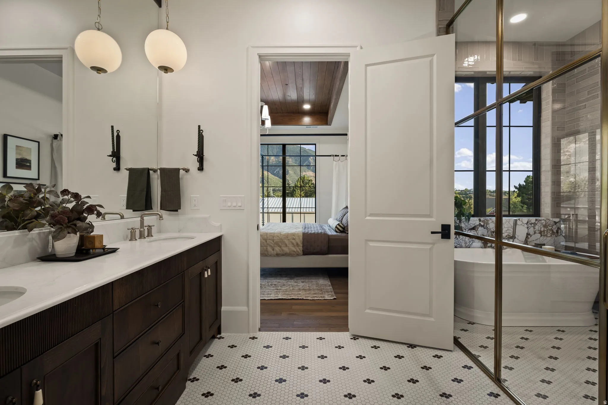 Bathroom featuring a dual vanity with a white countertop and dark wood cabinetry