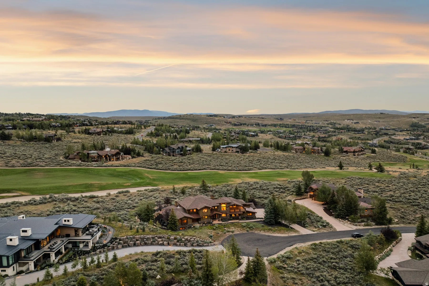 Expansive residential area with a golf course surrounded by natural high desert landscaping