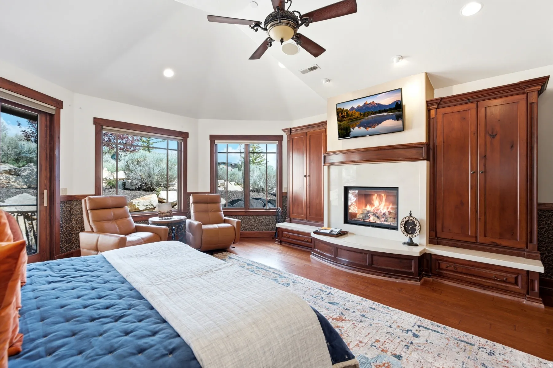 Vaulted ceilings complement the built-in fireplace featuring a light-toned surround and hearth