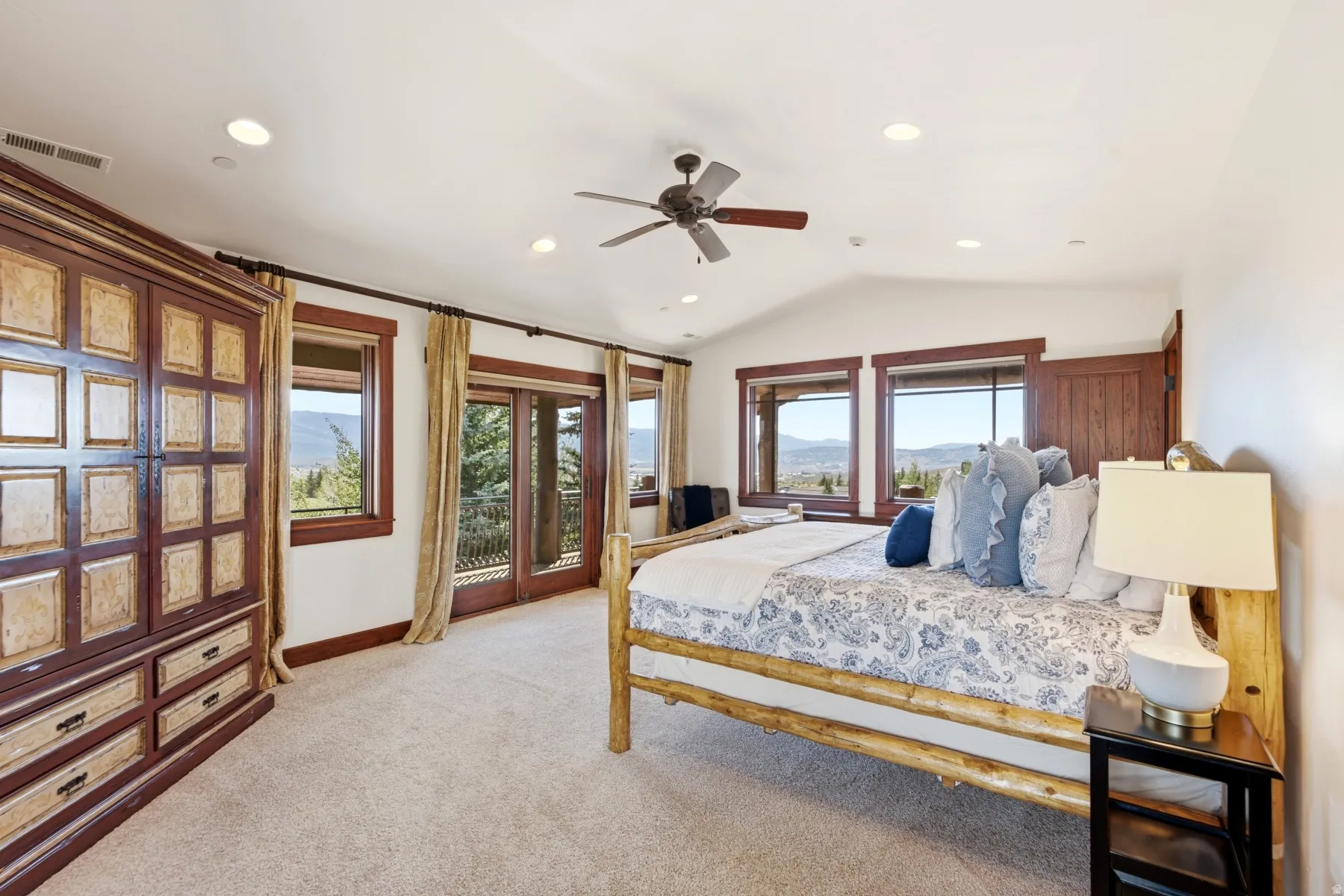 Spacious room featuring vaulted ceilings, recessed lighting, and a ceiling fan