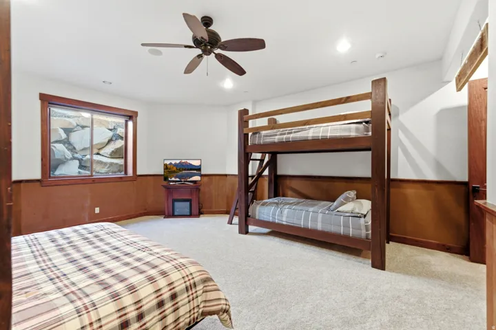 Carpeted room featuring a ceiling fan with light, recessed lighting, and wainscoting