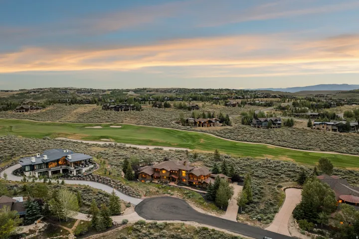 Expansive property featuring a golf course, numerous residences, and natural landscaping