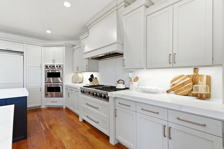 Gourmet kitchen featuring a built-in refrigerator, double ovens, and a commercial-style gas range
