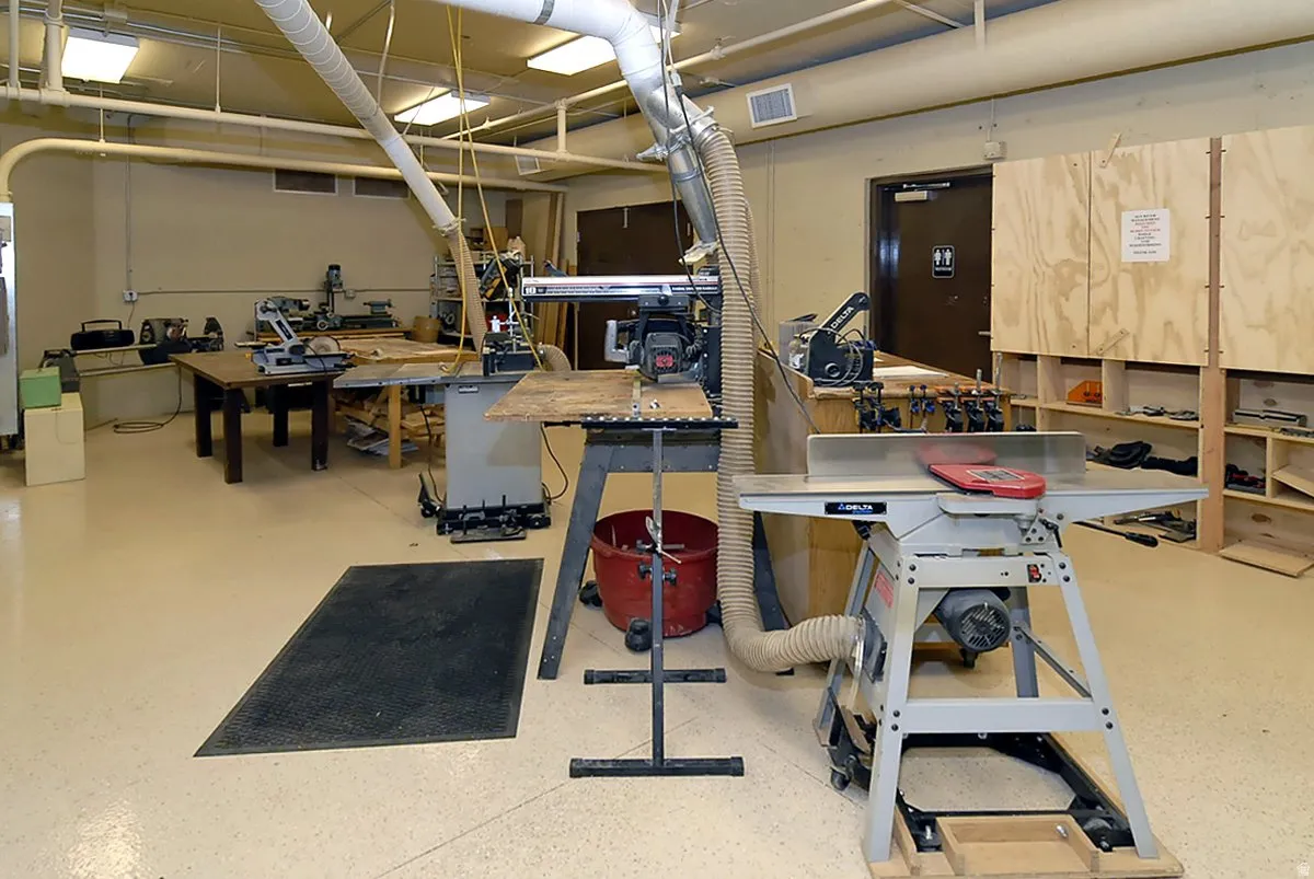 Industrial space featuring high ceilings, fluorescent lighting, and durable flooring