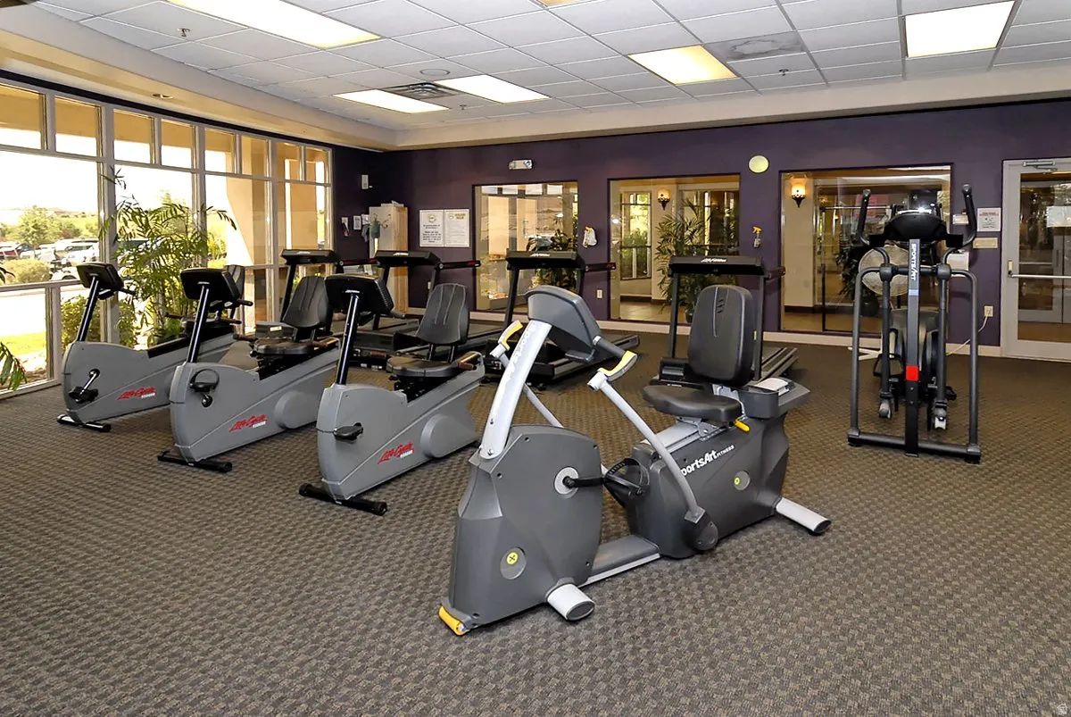 State-of-the-art fitness center featuring multiple cardio and strength training stations, including stationary bikes, elliptical machines, and weight-resistance equipment