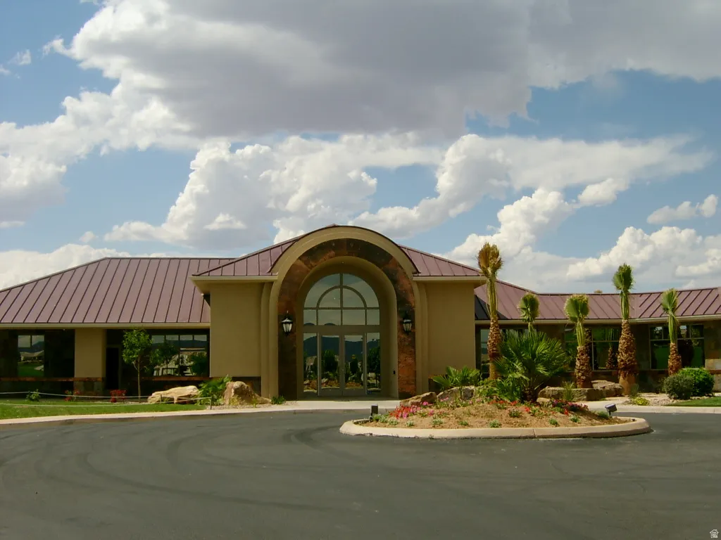 Distinctive curved entry facade with arched glass doors and sidelights anchors this contemporary residence