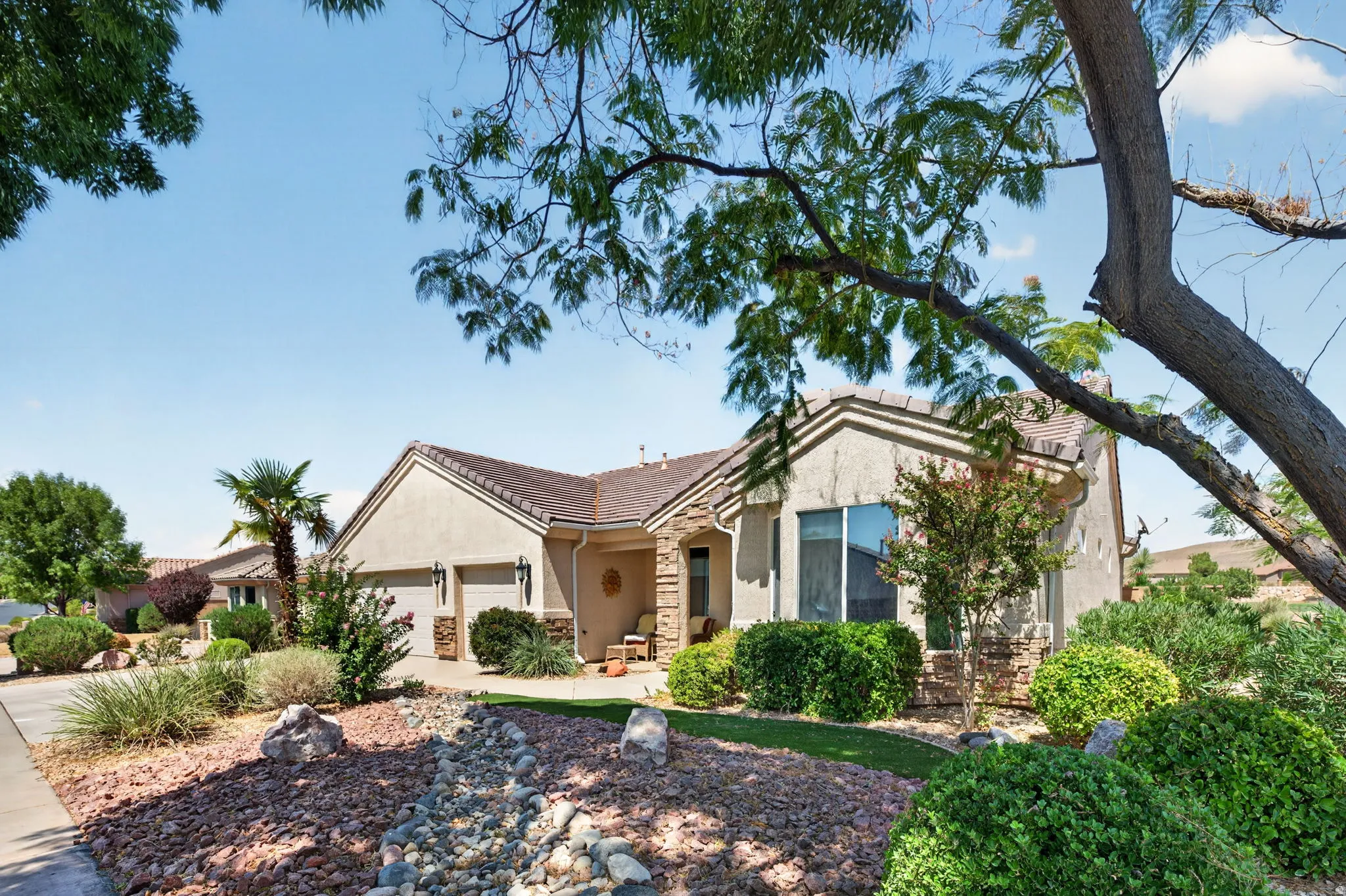 Southwestern-style residence featuring a stucco exterior and a tiled roof