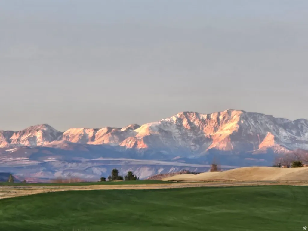 Expansive green space with distant mountain range