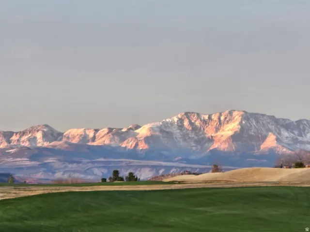 Expansive green space with distant mountain range