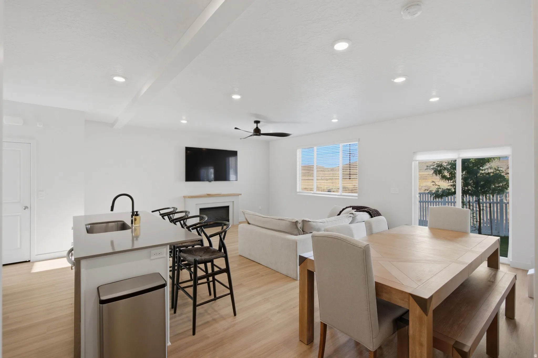 Open-concept living space featuring wood-finish flooring throughout