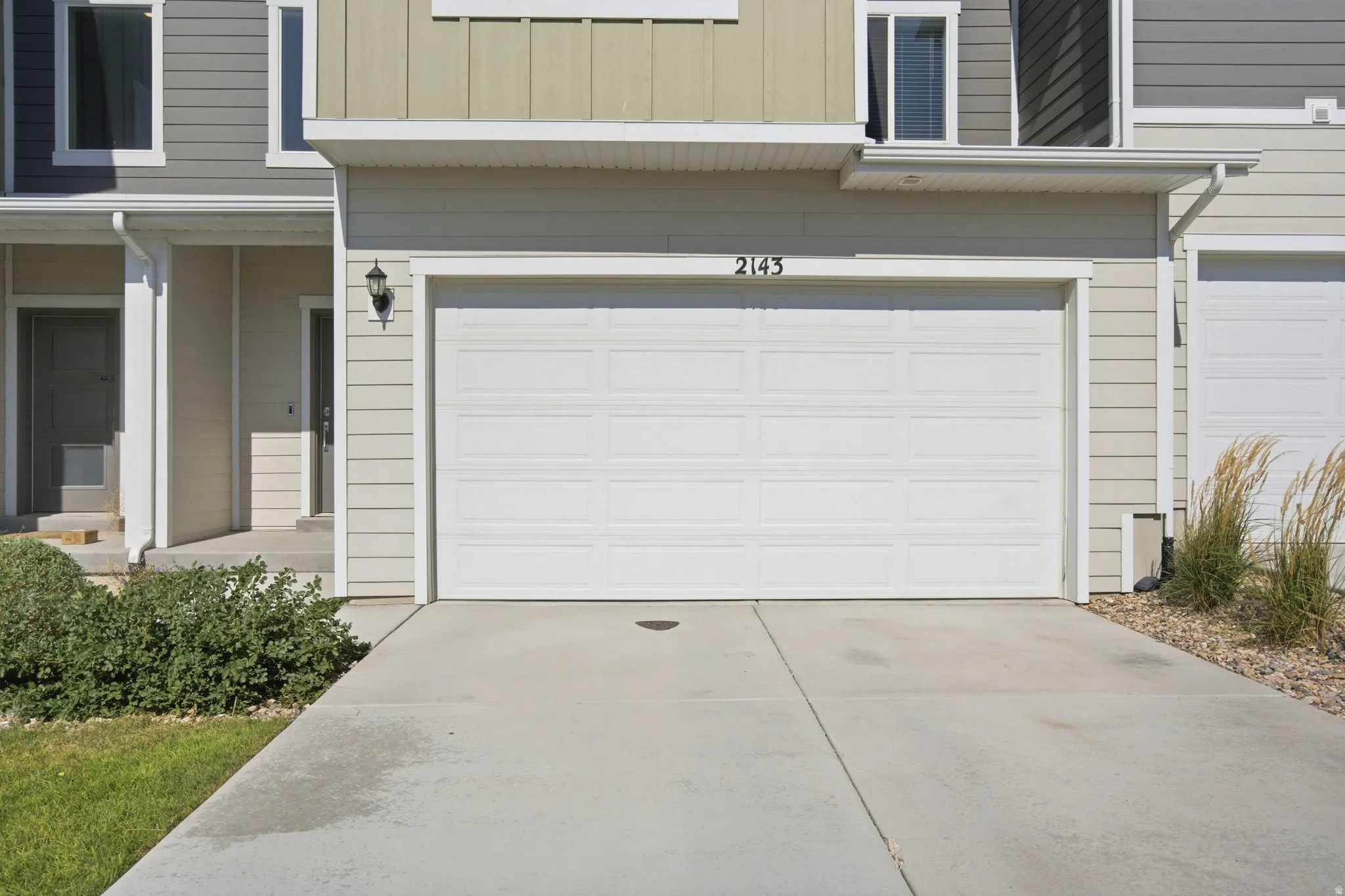 Two-car garage with a concrete driveway
