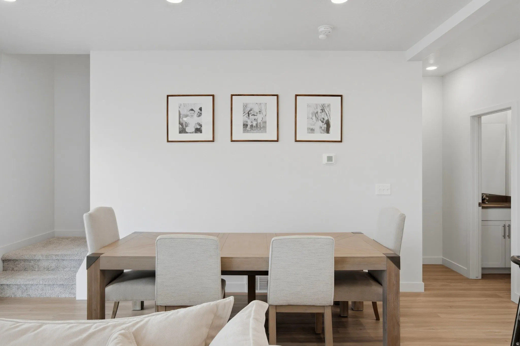 Open-concept living space with recessed lighting and light wood-finish flooring