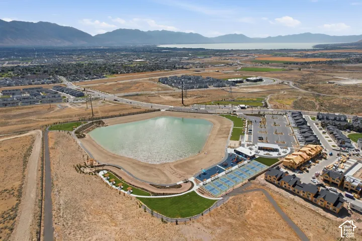 Aerial perspective showcasing a large residential community featuring a prominent central lake