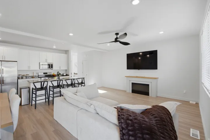 Open-concept living space featuring wood-finish flooring and recessed lighting